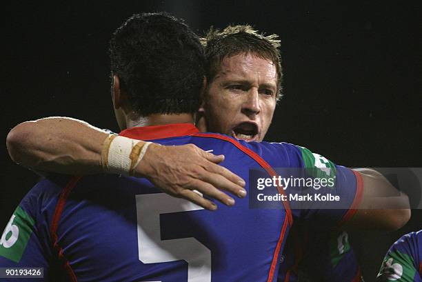 Kurt Gidley and Cooper Vuna of the Knights celebrate after a try during the round 25 NRL match between the Canberra Raiders and the Newcastle Knights...