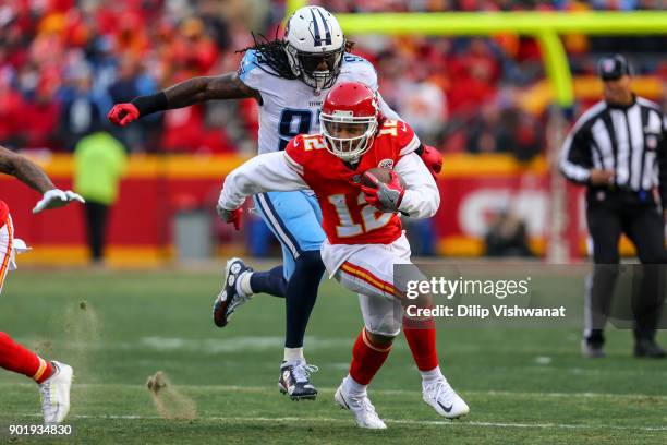 Wide receiver Albert Wilson of the Kansas City Chiefs runs away from would be tackler linebacker Erik Walden of the Tennessee Titans after a...