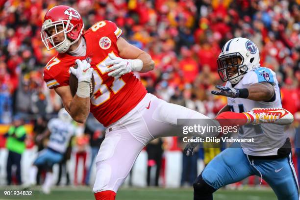 Tight end Travis Kelce of the Kansas City Chiefs catches the games first touchdown pass behind inside linebacker Avery Williamson of the Tennessee...