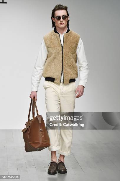 Model walks the runway at the Oliver Spencer Autumn Winter 2018 fashion show during London Menswear Fashion Week on January 6, 2018 in London, United...