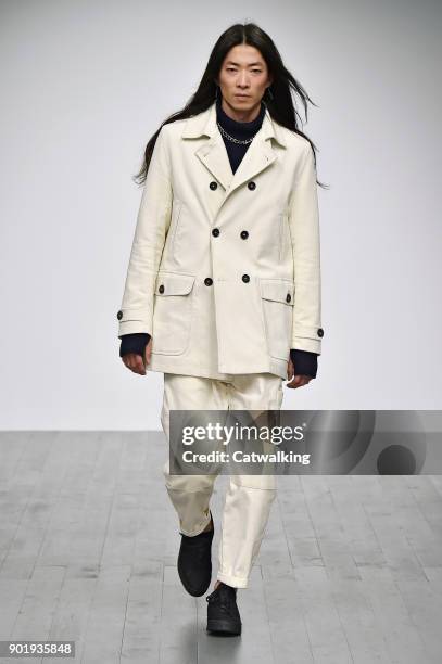 Model walks the runway at the Oliver Spencer Autumn Winter 2018 fashion show during London Menswear Fashion Week on January 6, 2018 in London, United...