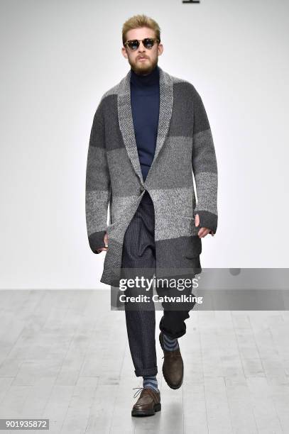 Model walks the runway at the Oliver Spencer Autumn Winter 2018 fashion show during London Menswear Fashion Week on January 6, 2018 in London, United...