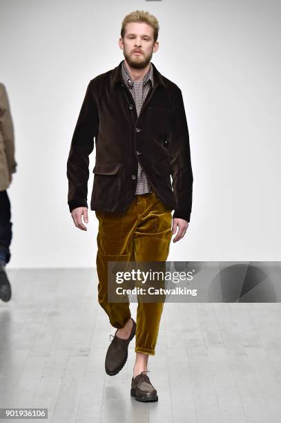 Model walks the runway at the Oliver Spencer Autumn Winter 2018 fashion show during London Menswear Fashion Week on January 6, 2018 in London, United...