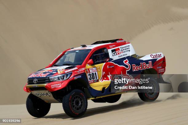 Nasser Al-Attiyah of Qatar and Toyota Gazoo Racing drives with co-driver Matthieu Baumel of France in the Hilux Toyota car in the Classe : T1.1 : 4x4...