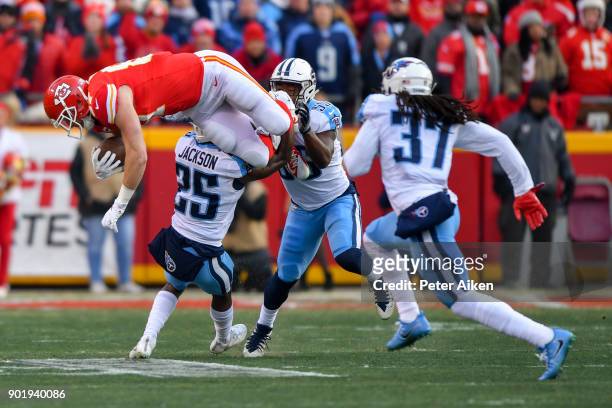 Tight end Travis Kelce of the Kansas City Chiefs goes up in the air while being tackled by cornerback Adoree' Jackson of the Tennessee Titans during...