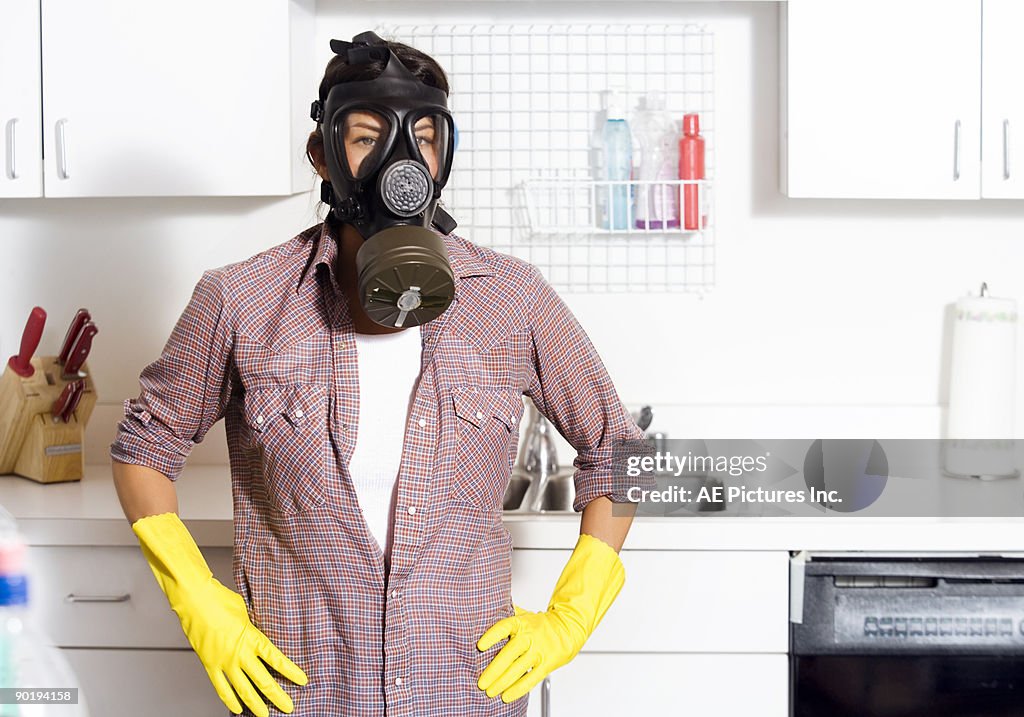 Woman in vintage gas mask cleaning