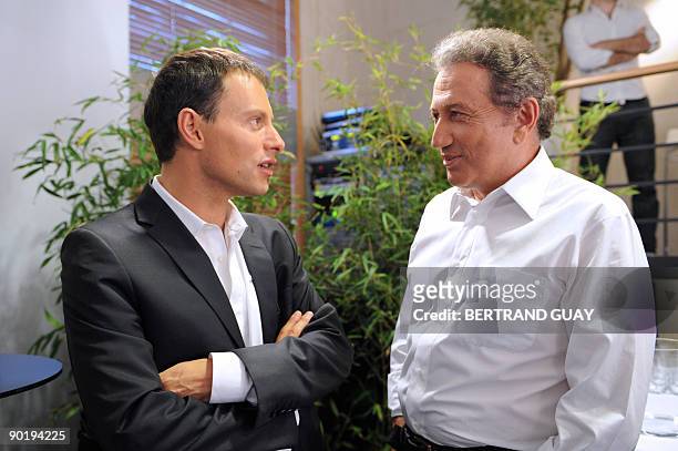 French journalist Marc-Olivier Fogiel speaks with Television host Michel Drucker after a press conference announcing the 2009/2010 programs of the...