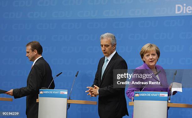 German Chancellor Angela Merkel looks on as Dieter Althaus , governor of the eastern German state of Thuringia an d Saxony's Governor Stanislaw...