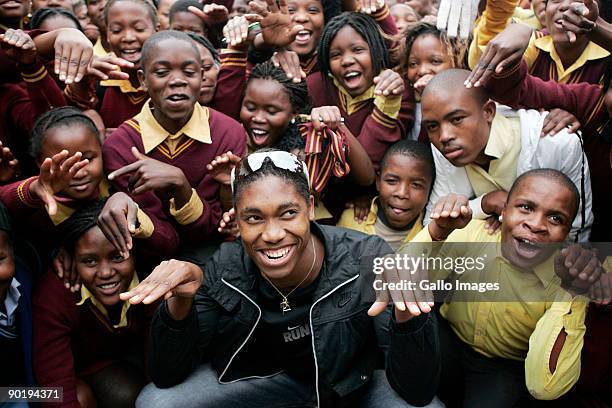 Caster Semenya greets the crowd during the street parade to celebrate her return to her home town of Masehlong village on August 30, 2009 in...