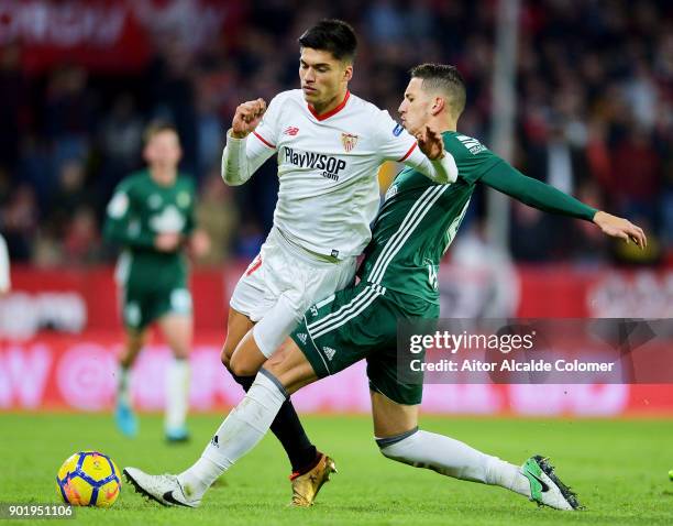 Joaquin Correa of Sevilla FC duels for the ball with Zouhair Feddal of Real Betis during the La Liga match between Sevilla FC and Real Betis Balompie...