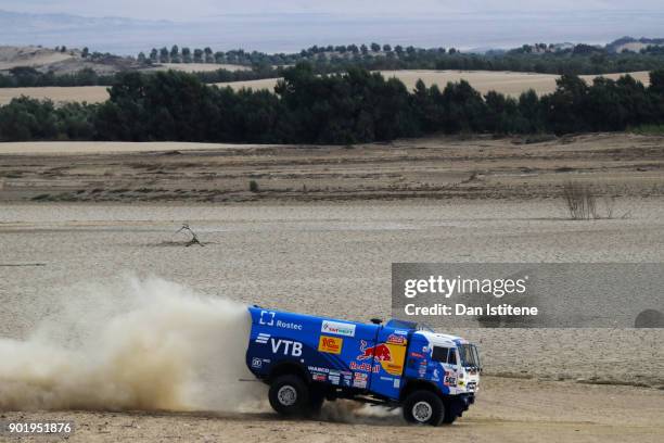 Dmitry Sotnikov of Russia and Team KAMAZ Master drives with co-driver Ruslan Akhmadeev of Russia and mechanic Ilnur Mustafin of Russia in a 43509...