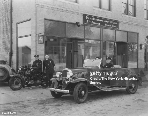 Exterior view, with officers in police car and motorcycle, of Valley Stream Police Station, 5th Precinct, Nassau County, New York, 1929.