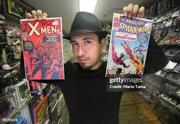 Employee Ryan Mundaca holds vintage Spider Man and X-Men Marvel comic books at St. Mark's Comics August 31, 2009 in New York City. The Walt Disney...