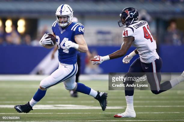 Jack Doyle of the Indianapolis Colts runs with the ball chased by Zach Cunningham of the Houston Texans during the first half at Lucas Oil Stadium on...