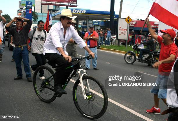 Ousted Honduran President Manuel Zelaya arrives in his bike to take part in a march of presidential candidate for the Opposition Alliance Against the...