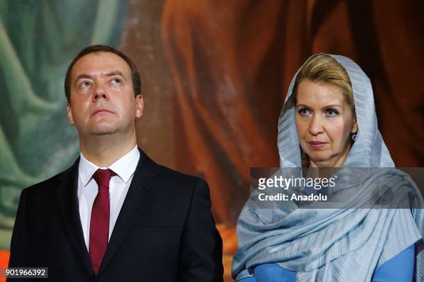 Russian Prime Minister Dmitry Medvedev and his wife Svetlana Medvedeva attend Orthodox Christmas service in Christ the Saviour cathedral in Moscow,...