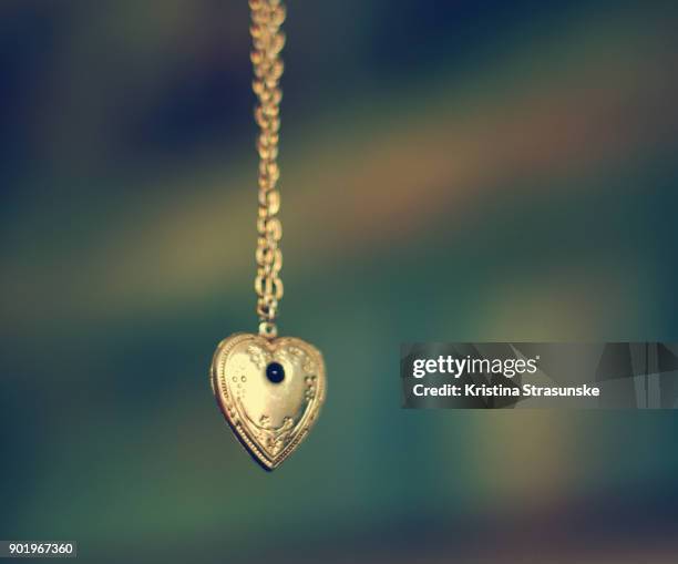 necklace with heart pendant - hangers stockfoto's en -beelden