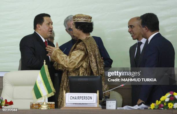 Libyan leader Moamer Kadhafi welcomes his Venezuelan counterpart Hugo Chavez during a special African Union summit in Tripoli on August 31 on the eve...