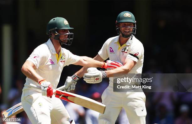 Mitchell Marsh of Australia celebrates with his brother Shaun Marsh of Australia after scoring a century and alerts him to a possible runout during...