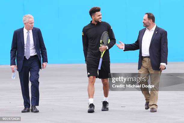 Jo-Wilfried Tsonga of France arrives with Acting Sports Minister Philip Dalidakis and Australian Open Tournament Director Craig Tiley ahead of the...