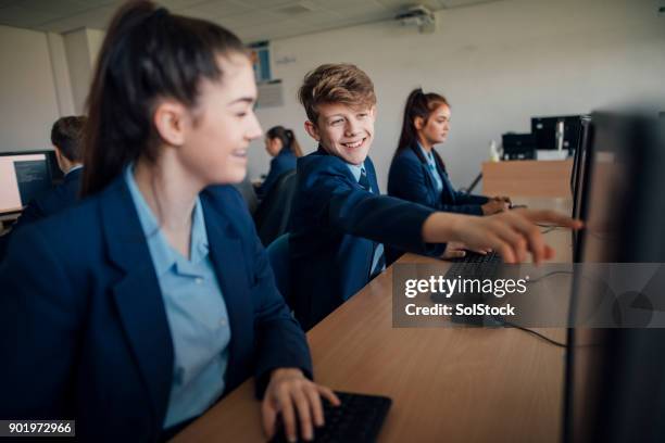 laughing at the computer - classroom laptop stock pictures, royalty-free photos & images