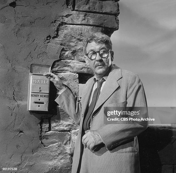 Actor Burgess Meredith as Henry Bemis, in a scenes from "Time Enough at Last", episode 8 from the first season of the CBS series 'The Twilight Zone',...