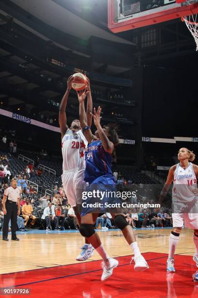 Sancho Lyttle of the Atlanta Dream rebounds against Taj McWilliams of the Detroit Shock during the game at Philips Arena on August 13, 2009 in...