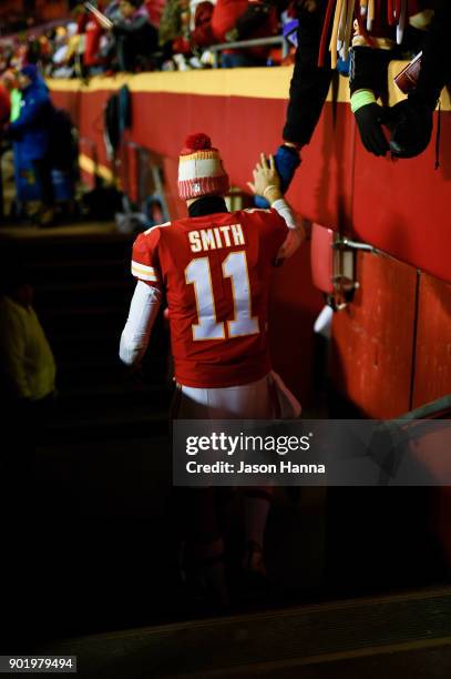 Quarterback Alex Smith of the Kansas City Chiefs high fives the crowd as he walks off the field following the loss to the Tennessee Titans after the...