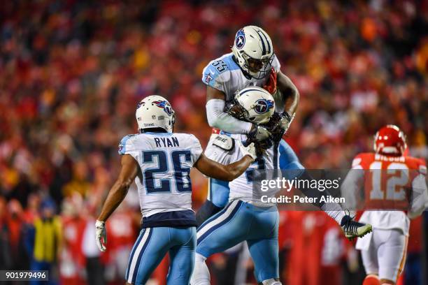 Strong safety Johnathan Cyprien of the Tennessee Titans celebrates with teammate linebacker Jayon Brown after knocking a ball loose on fourth down...