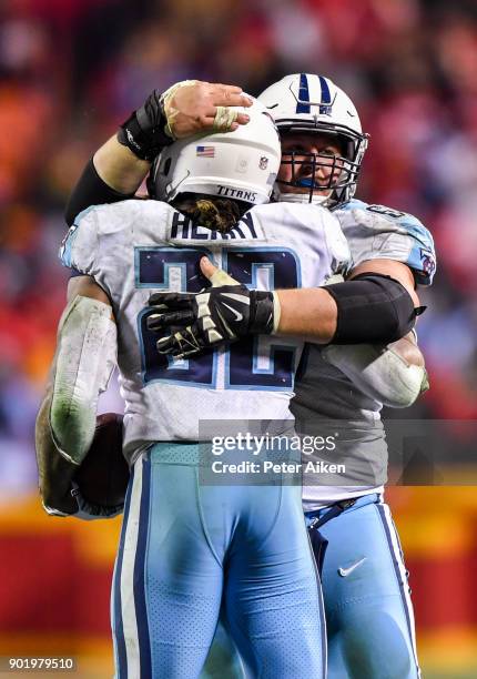 Running back Derrick Henry of the Tennessee Titans gets a hug from a teammate after sealing the game on a first down run against the Kansas City...
