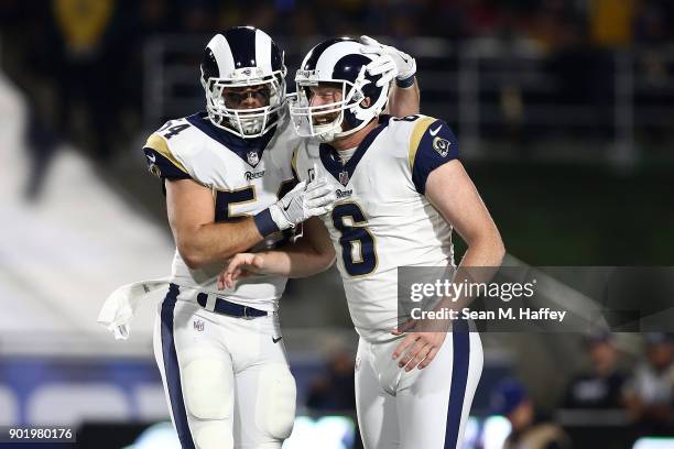 Johnny Hekker of the Los Angeles Rams celebrates with Bryce Hager after Hekker punts 66 yards in the first quarter during the NFC Wild Card Playoff...