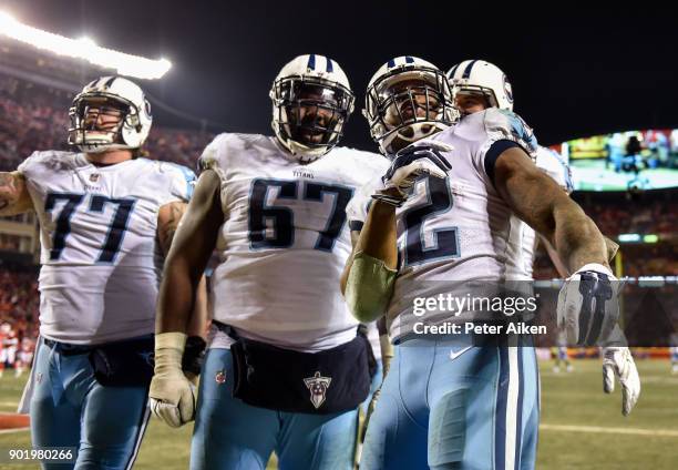 Running back Derrick Henry of the Tennessee Titans celebrates with teammates offensive tackle Taylor Lewan and offensive guard Quinton Spain after...