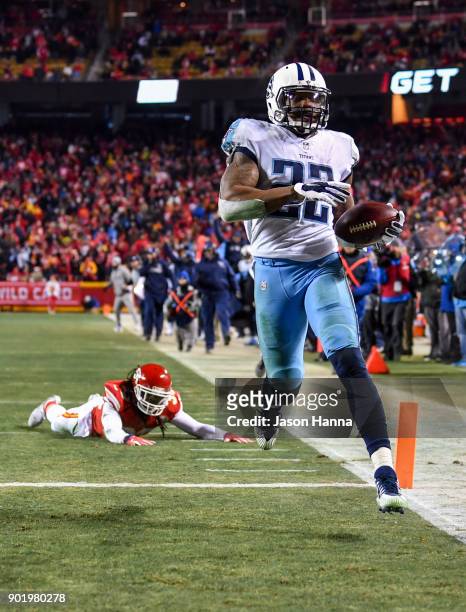 Running back Derrick Henry of the Tennessee Titans breaks free from the tackle attempt of free safety Ron Parker of the Kansas City Chiefs on his way...
