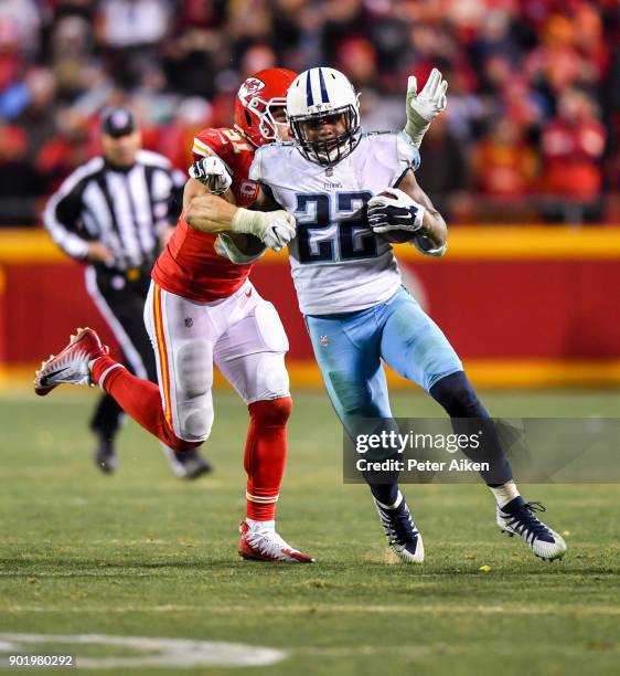 Running back Derrick Henry of the Tennessee Titans breaks free from the tackle attempt of outside linebacker Frank Zombo of the Kansas City Chiefs...