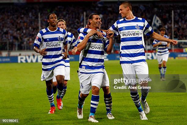 Mihai Tararache of Duisburg celebrates his team's first goal with team mates Sandro Wagner and Caiuby during the 2. Bundesliga match between MSV...