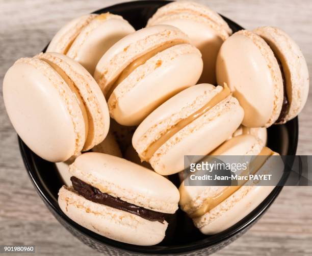 aerial view of macaroons piled in a black cup - jean marc payet stock-fotos und bilder
