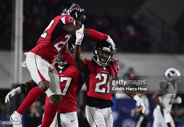 Cornerback Desmond Trufant of the Atlanta Falcons celebrates his defensive play with teammates during the first quarter of the NFC Wild Card Playoff...
