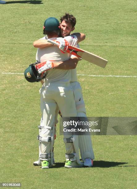 Mitch Marsh of Australia celebrates his century with brother Shaun Marsh during day four of the Fifth Test match in the 2017/18 Ashes Series between...