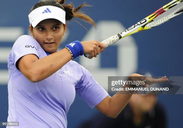 Indian tennis player Sania Mirza returns a shot to Olga Govortsova of Belarus during the first round of the US Open at the USTA Billie Jean King...