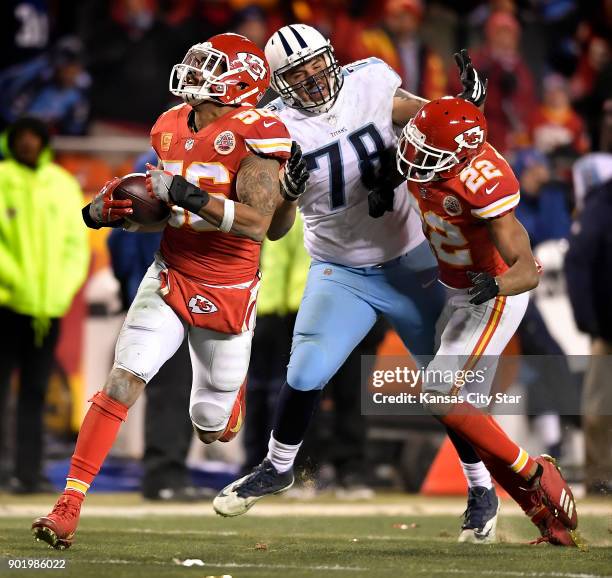 Kansas City Chiefs inside linebacker Derrick Johnson returns a fumble to the end zone past Tennessee Titans offensive tackle Jack Conklin late in the...