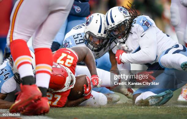 Kansas City Chiefs running back Kareem Hunt crashes into the end zone as the Tennessee Titans' Avery Williamson makes the tackle on Saturday, Jan. 6...