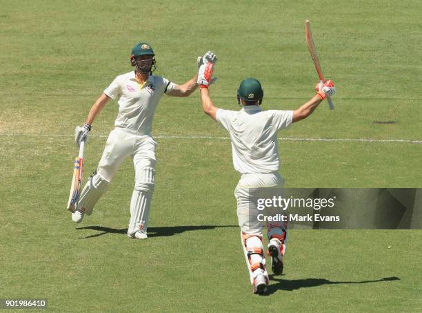 Mitch Marsh of Australia celebrates his century with brother Shaun Marsh during day four of the Fifth Test match in the 2017/18 Ashes Series between...