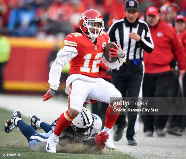 Kansas City Chiefs wide receiver Albert Wilson tries to dodge an ankle tackle by the Tennessee Titans' Erik Walden in the first quarter on Saturday,...