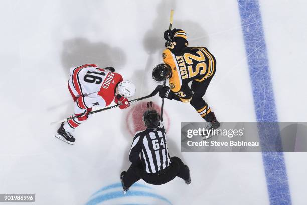 Marcus Kruger of the Carolina Hurricanes faces off against Sean Kurlay of the Boston Bruins at the TD Garden on January 6, 2018 in Boston,...