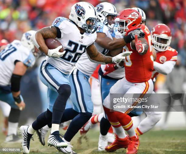 Tennessee Titans running back Derrick Henry tries to turn the corner as Kansas City Chiefs outside linebacker Justin Houston reaches out to slow him...