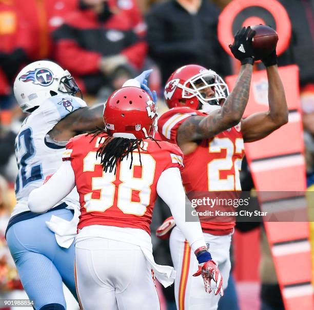 Kansas City Chiefs cornerback Marcus Peters picks off a pass intended for the Tennessee Titans' Delanie Walker as Ron Parker helps on the coverage in...