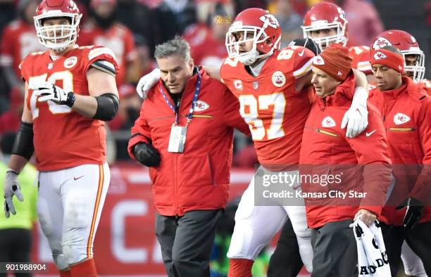 Kansas City Chiefs tight end Travis Kelce is helped off the field following a hit by the Tennessee Titans' Johnathan Cyprien in the second quarter on...