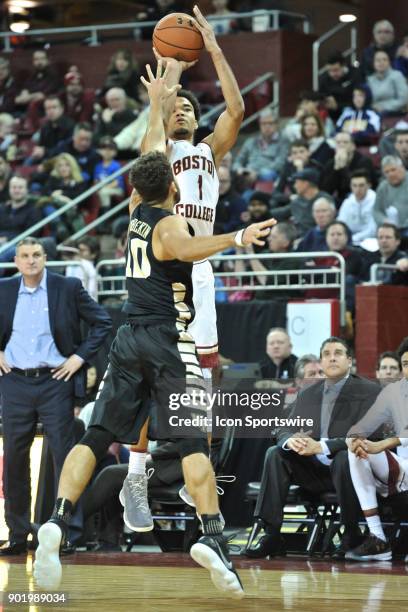 Boston College Eagles guard Jerome Robinson goes up over Wake Forest Demon Deacons guard Mitchell Wilbekin for a three pointer. During the Boston...