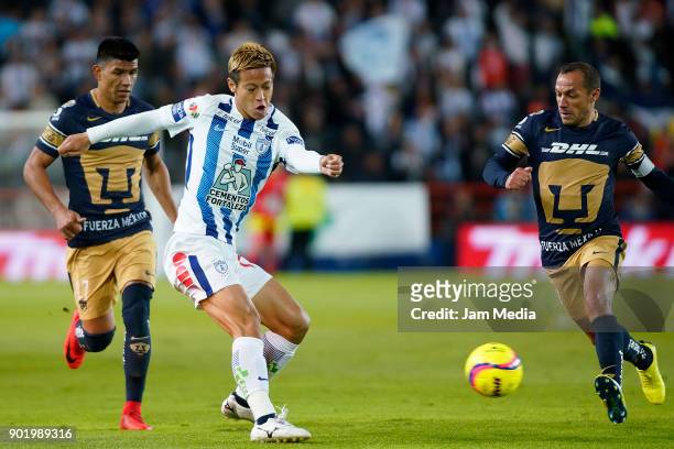 Keisuke Honda of Pachuca drives the ball while followed by Marcelo Diaz of Pumas during the first round match between Pachuca and Pumas UNAM as part...