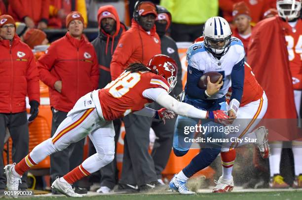 Kansas City Chiefs free safety Ron Parker tackles Tennessee Titans quarterback Marcus Mariota along the Chiefs sideline in the fourth quarter on...